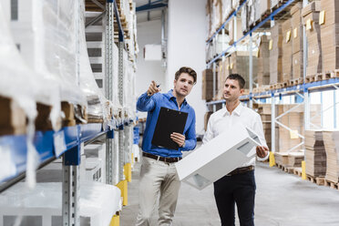 Two businessmen having a meeting in company warehouse - DIGF03013