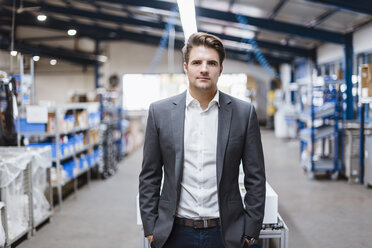 Young manager standing in shop floor, portrait - DIGF03037
