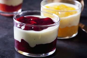 Red and yellow fruit compote with vanilla sauce layered in glasses - CSF28392