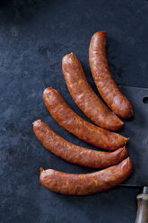 Five minced meat sausages on dark background - CSF28458