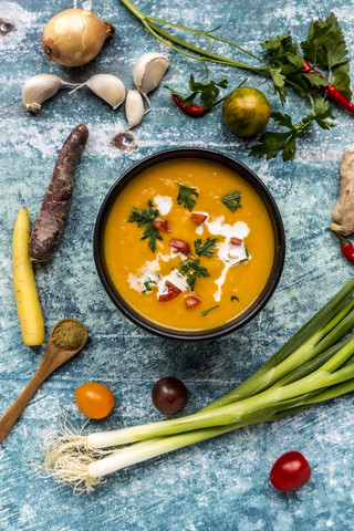 Sweet potato soup with carrot, tomato, leek, garlic, parsley and cumin stock photo