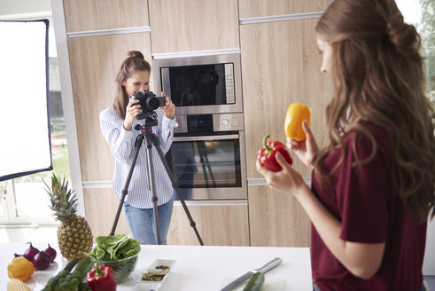 Woman recording friend while preparing healthy food - ABIF00026