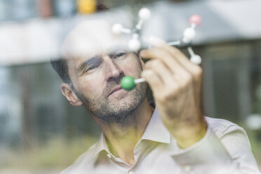 Portrait of scientist with atomic model - UUF12084