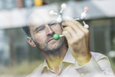 Portrait of scientist with atomic model - UUF12084