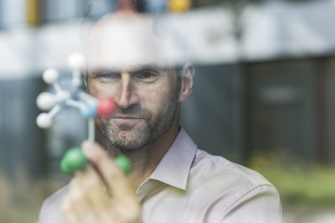 Portrait of scientist with atomic model stock photo