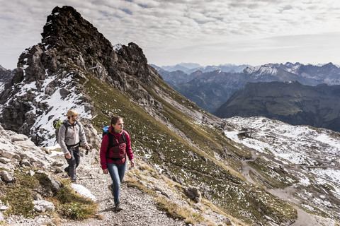 Germany, Bavaria, Oberstdorf, two hikers walking in alpine scenery stock photo