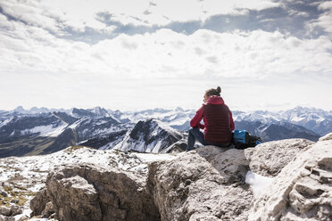 Germany, Bavaria, Oberstdorf, hiker sitting in alpine scenery - UUF12125