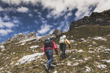 Germany, Bavaria, Oberstdorf, two hikers walking up alpine meadow - UUF12146