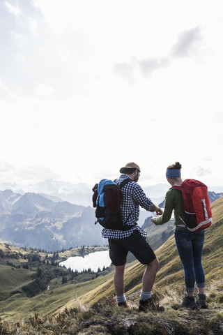 Germany, Bavaria, Oberstdorf, two hikers with map in alpine scenery stock photo