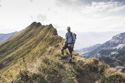 Germany, Bavaria, Oberstdorf, hiker standing on mountain ridge in alpine scenery stock photo