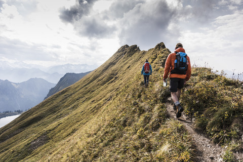 Germany, Bavaria, Oberstdorf, two hikers walking on mountain ridge stock photo