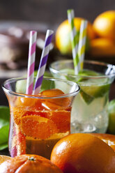 Fruit spritzer of tangerines and lime in a glass with drinking straws - CSF28483