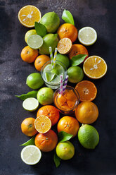 Limetten, Zitronen, Orangen und Mandarinen auf dunklem Hintergrund - CSF28484