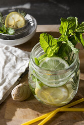 Glass of detox water with mint, ginger, rosmary and limes - CSTF01415