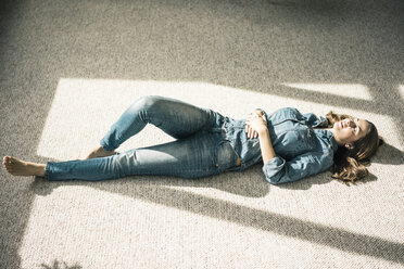 A Woman Lying Down on the Floor Looking Depressed · Free Stock Photo