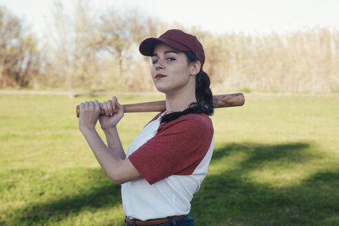 Portrait of young woman with baseball bat in park - RTBF01082