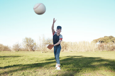 Young man throwing a baseball in park - RTBF01084