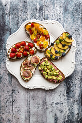 Various sandwiches, strawberry, fig, nectarine, avocado, tomato, on plate - SARF03404