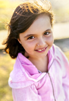 Portrait of smiling little girl with blowing hair - MGOF03671
