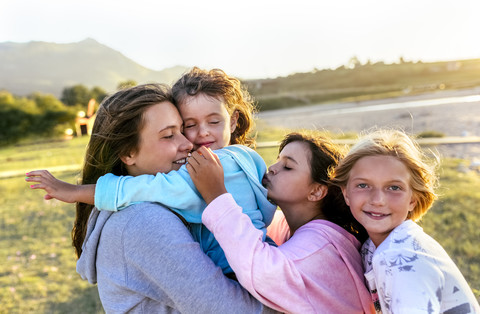 Group of four girls having fun together in nature stock photo