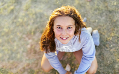 Portrait of smiling girl at twilight looking up - MGOF03684