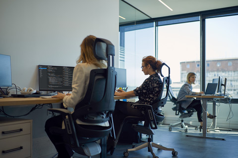 Businesswomen using computers in office stock photo