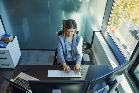 Businesswoman using computer in office stock photo