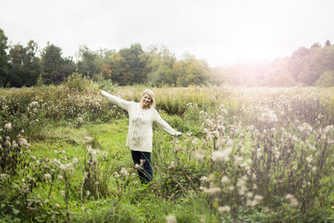 Portrait of happy blond woman in the nature - MOEF00250