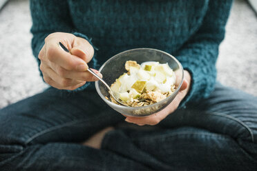 Close-up of woman eating fruit muesli - MOEF00277