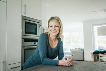 Portrait of smiling blond woman at home - MOEF00290