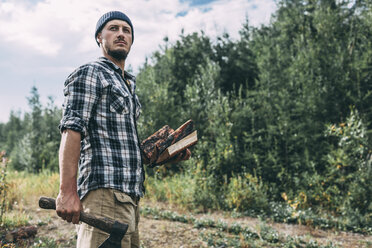 Man chopping wood in rural landscape - VPIF00253