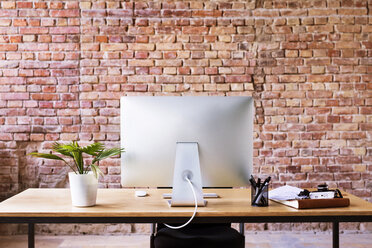 Workspace with brick wall in office - HAPF02334