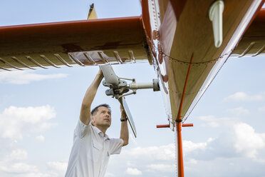 Pilot checking helicopter before start - OJF00201