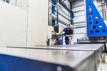 Man working on machine in industrial factory - DIGF03108