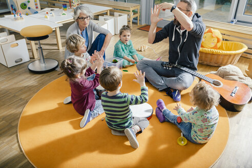 Kinder und Erzieherinnen spielen und musizieren im Kindergarten - MFF04083