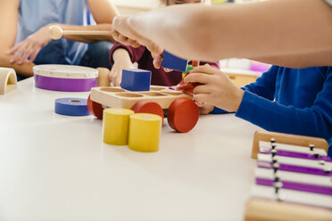 Close-up of children playing with musical instruments and toys in kindergarten - MFF04091