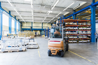 Man on forklift in factory warehouse - DIGF03163