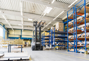 Man on forklift in factory warehouse - DIGF03165