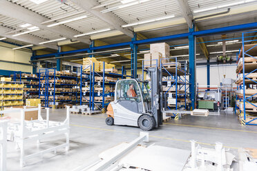 Man on forklift in factory warehouse - DIGF03167