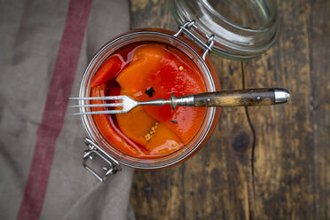 Pickled roasted bell pepper, open preserving jar and fork - LVF06397