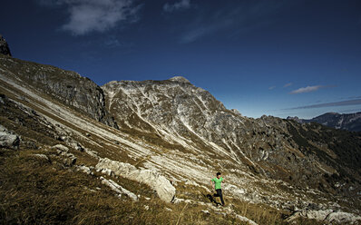 Germany, Allgaeu Alps, man running in mountains - MALF00010