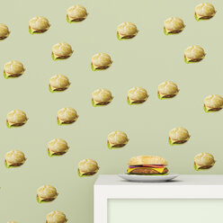 Plate with Hamburger on cup board in front of wallpaper with Hamburger pattern, 3D Rendering - UWF01297