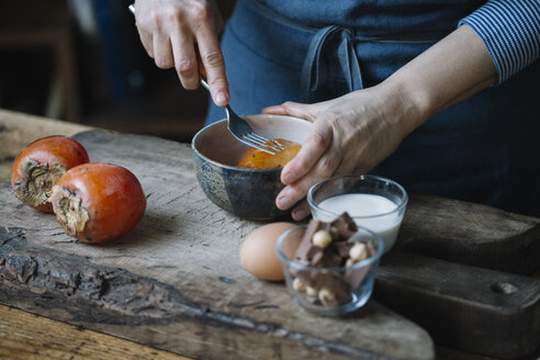 Woman mashing persimmonfor preparing dessert - ALBF00187