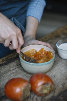 Woman mashing persimmonfor preparing dessert - ALBF00188