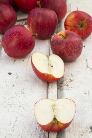 Red apples on wood, halved stock photo