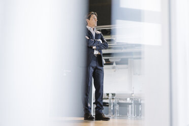 Businessman standing on office floor - JOSF01852