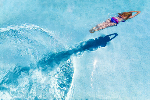 Spain, woman diving in swimming pool - SMAF00852