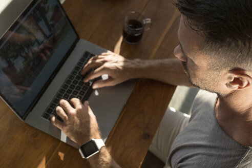 Mature man working on laptop, close-up - SBOF00881