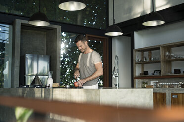 Mature man standing in kitchen, preparing healthy breakfast - SBOF00883