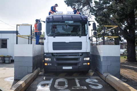 Workers in reflective vests loading truck stock photo